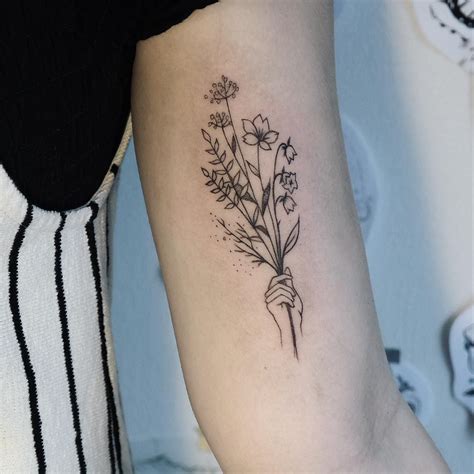 A yellow tulip is a symbol of unrequited love. . Minimalist flower bouquet tattoo